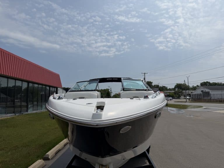 Modern speedboat displayed outside Hall's Sport Center in a sunny outdoor setting.