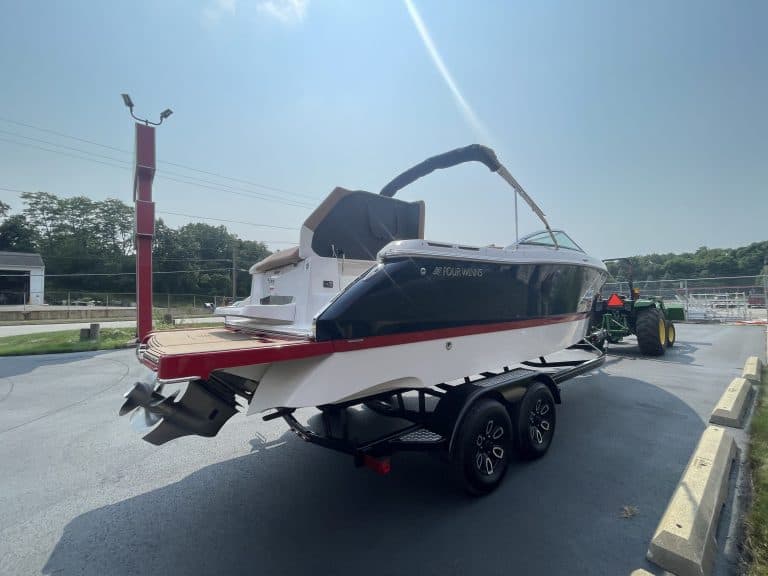 Luxury Four Winns H260 boat on trailer at dealership.