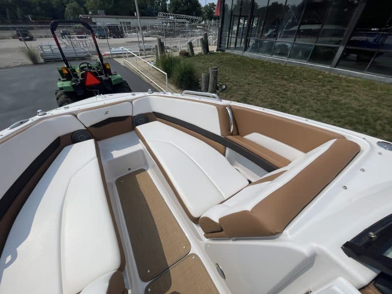 Luxury boat interior with cushioned seating and open deck space.