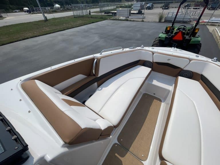 Luxury boat interior with cushioned seating and open deck space.