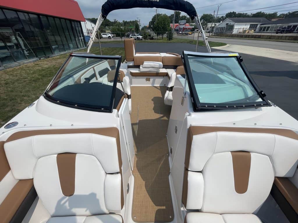 Interior view of a 2018 Four Winns H260 boat with white and brown seating.