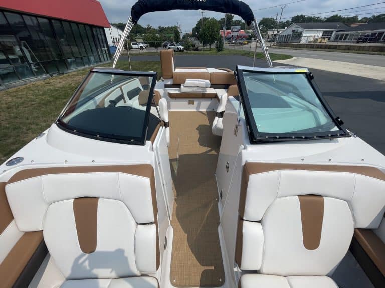Interior view of a 2018 Four Winns H260 boat with white and brown seating.