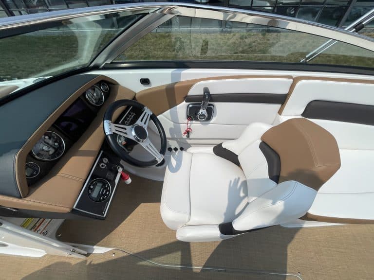Close-up of the helm and seating area of a Four Winns H260 boat.