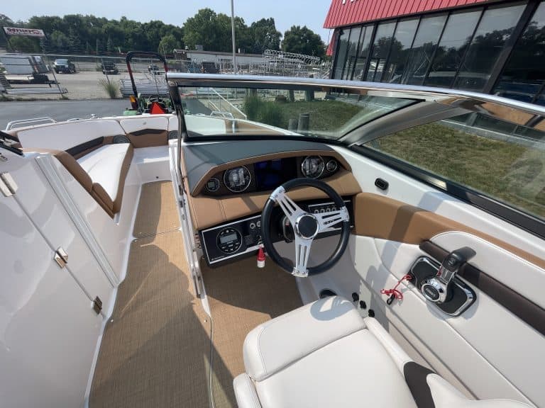Boat dashboard and steering wheel of a 2018 Four Winns H260.