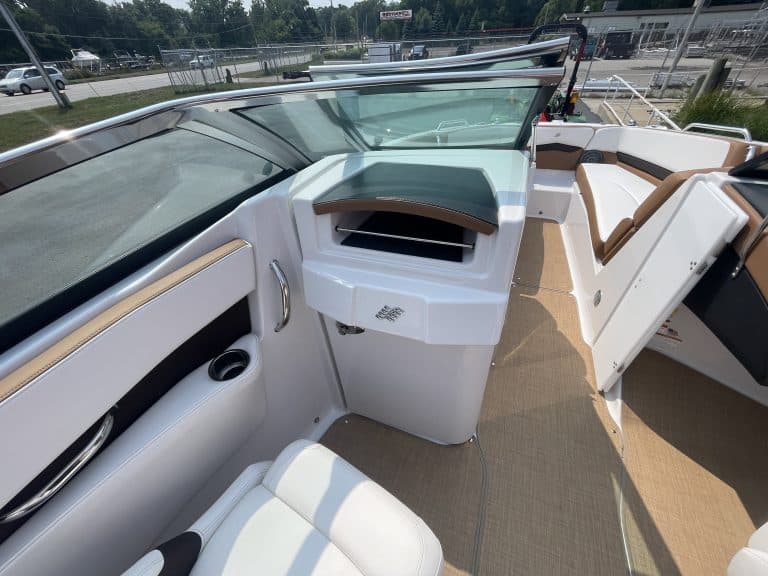 Interior view of a 2018 Four Winns H260 boat with seating and dashboard.