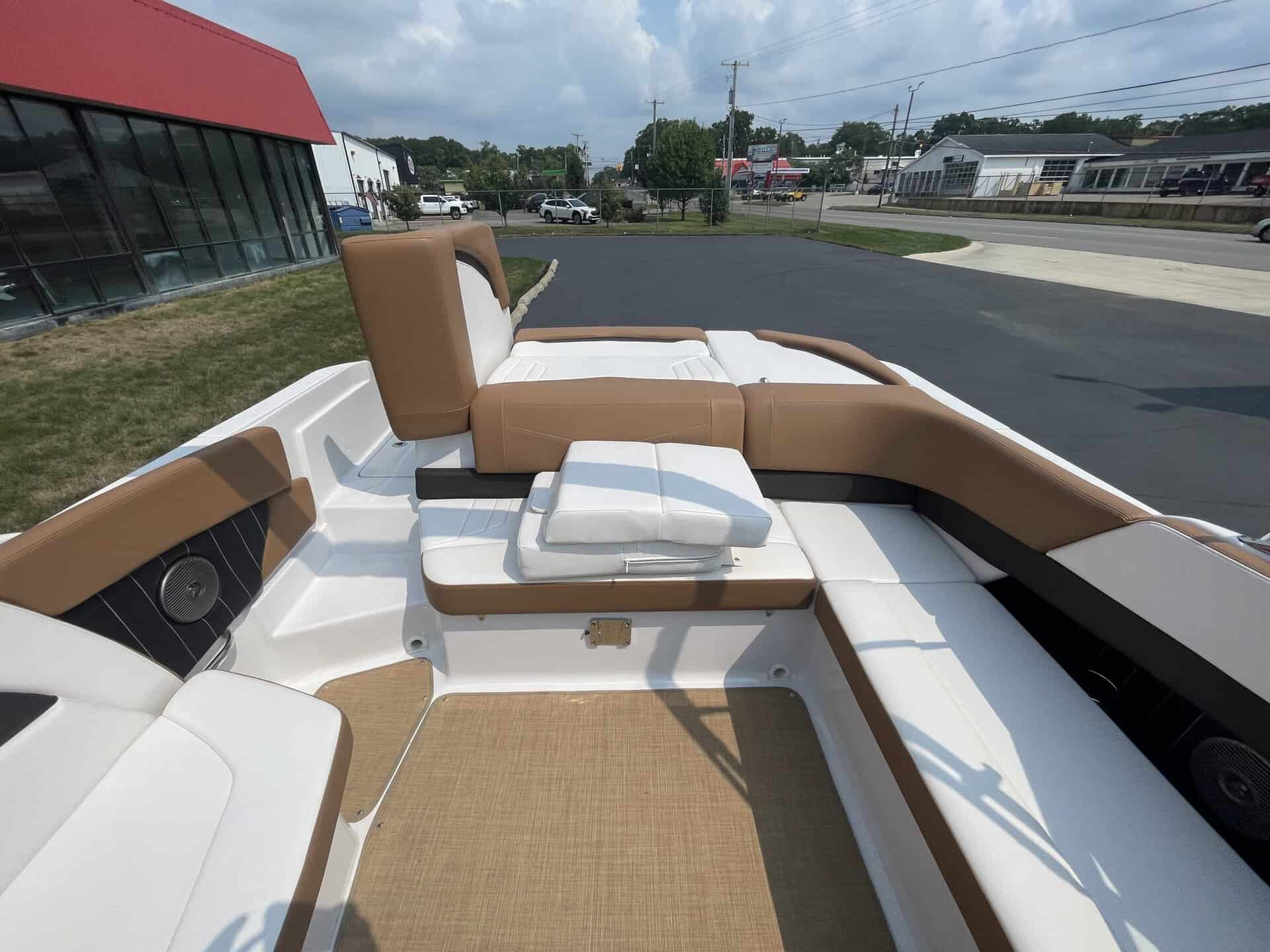 Luxury boat interior with brown and white seating for Four Winns H260.