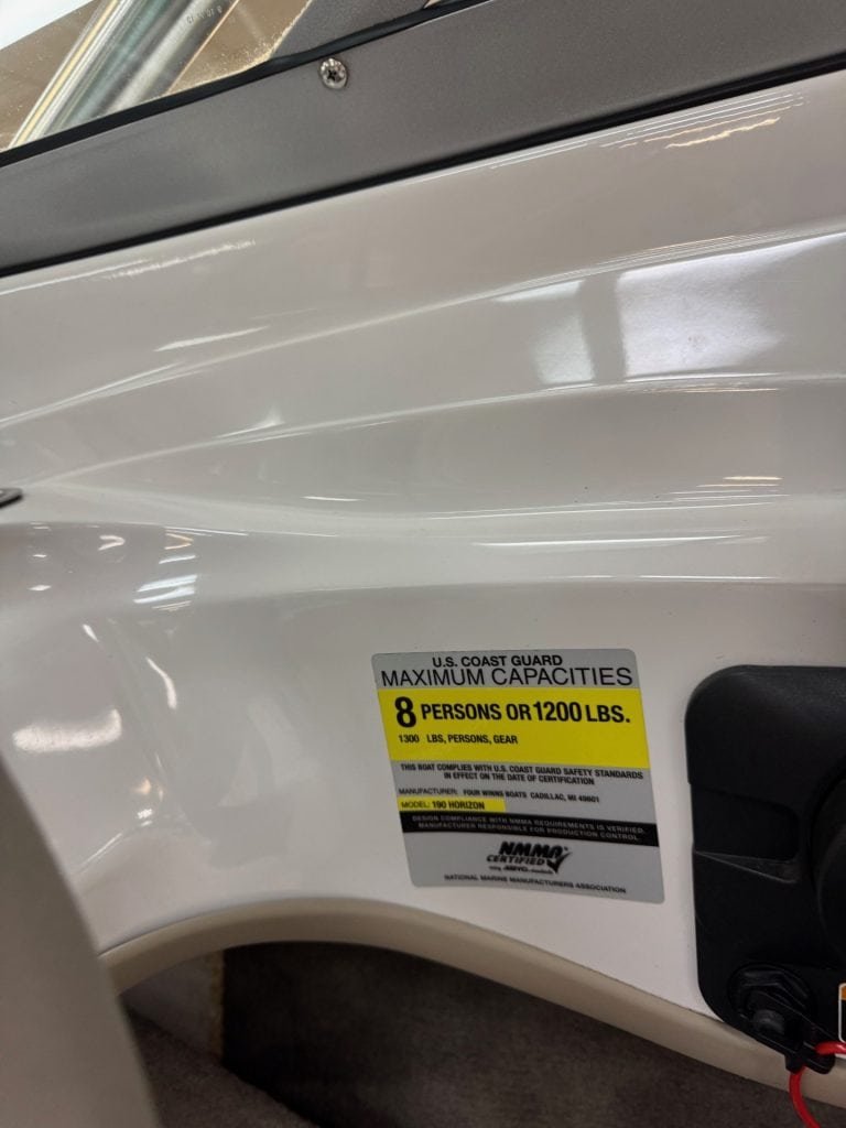 Aluminum boat with capacity sticker for safety and regulations.