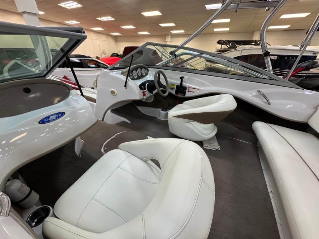 Elegant boat interior with white seating and dashboard.