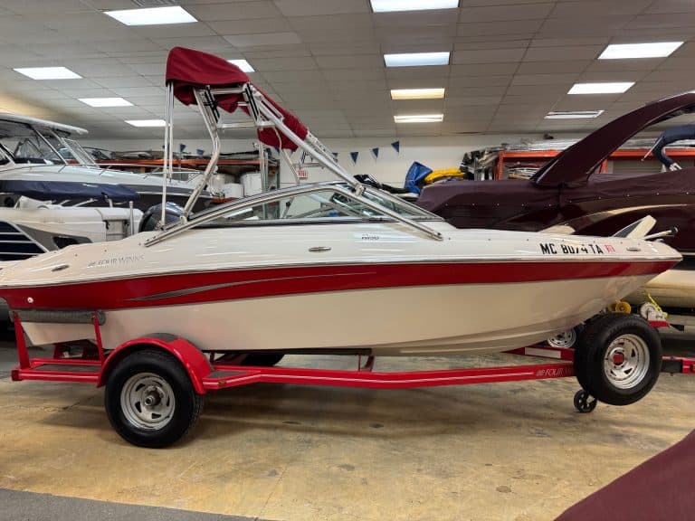Four Winns H190 boat on a red trailer at Hall's Sport Center.