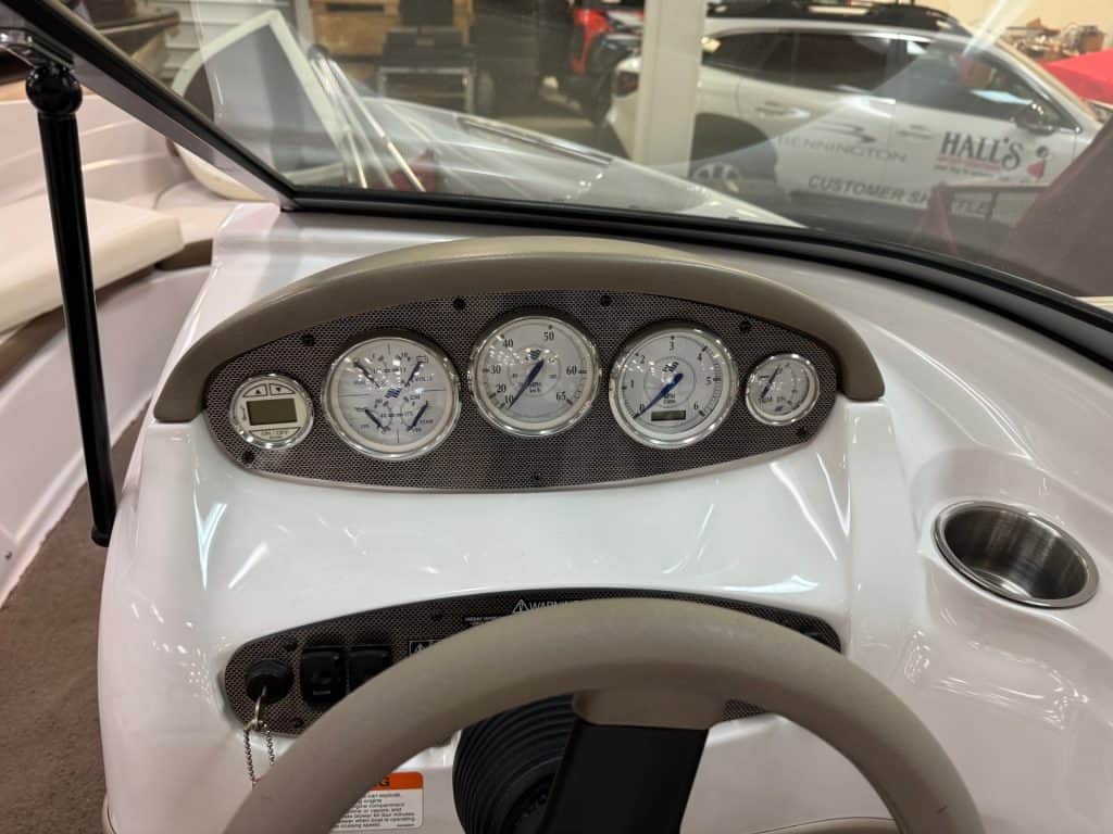 Close-up of 2008 Four Winns H190 boat dashboard with gauges and controls.