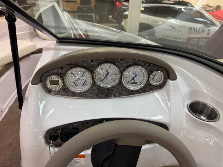 Close-up of 2008 Four Winns H190 boat dashboard with gauges and controls.