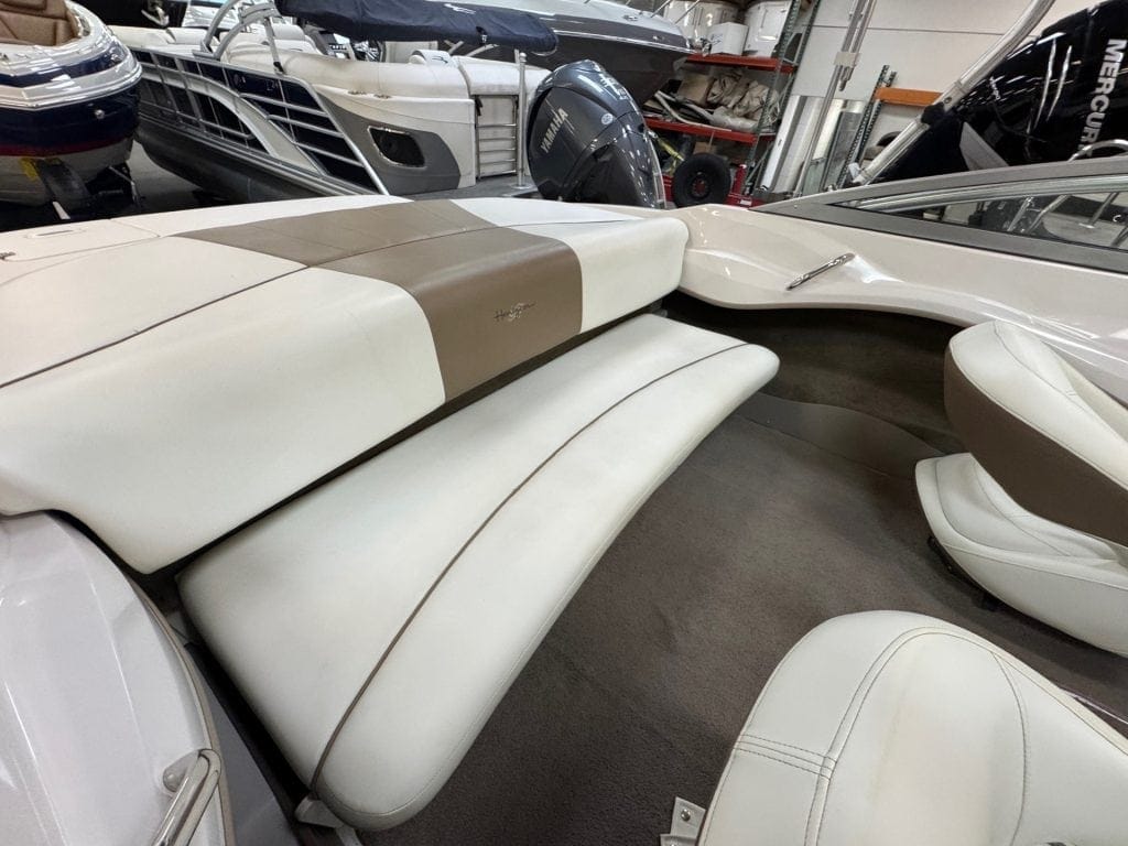 Boat interior with white and beige seating at Hall's Sport Center.