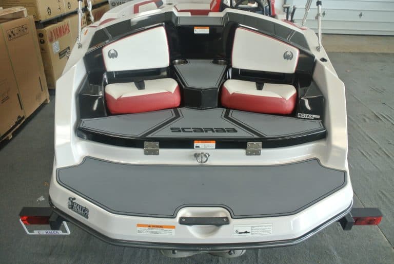 Modern speed boat with white, black, and red accents, equipped for water sports.