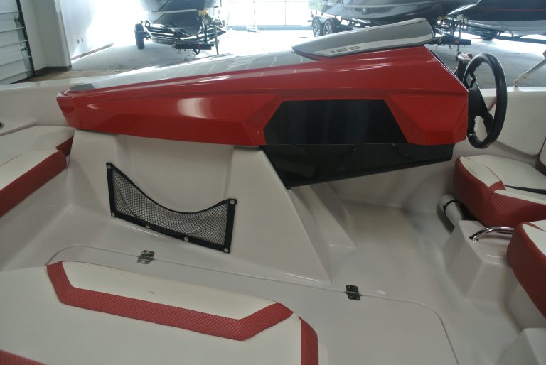 Close-up view of racing boat interior with sleek red and white design, perfect for speed enthusiasts and boating supply seekers.
