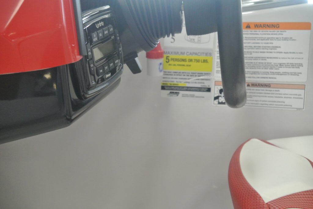 Close-up of fuel gauge and warning labels on power equipment at Hall's Sport Center, offering durable outdoor gear and sports products.