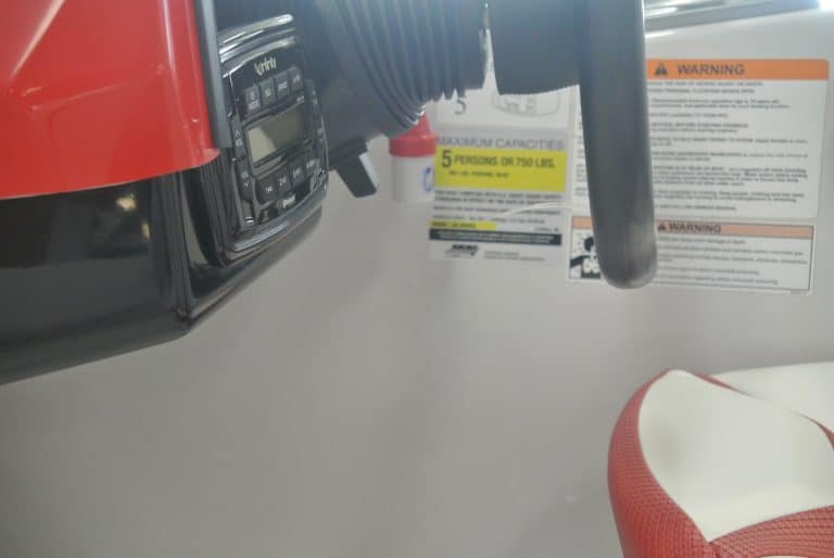 Close-up of fuel gauge and warning labels on power equipment at Hall's Sport Center, offering durable outdoor gear and sports products.