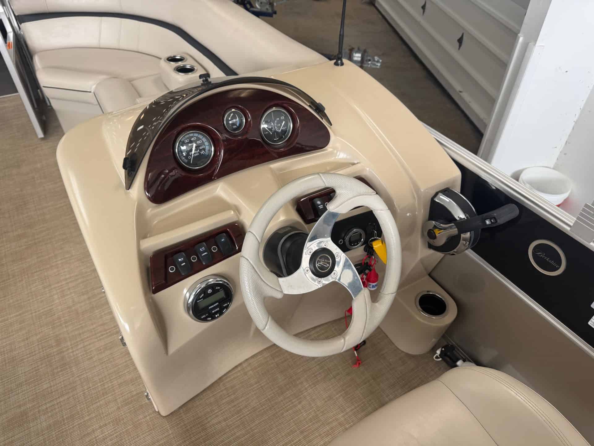 High-quality Berkshire 22SR boat dashboard with gauges and steering wheel at Hall's Sport Center.