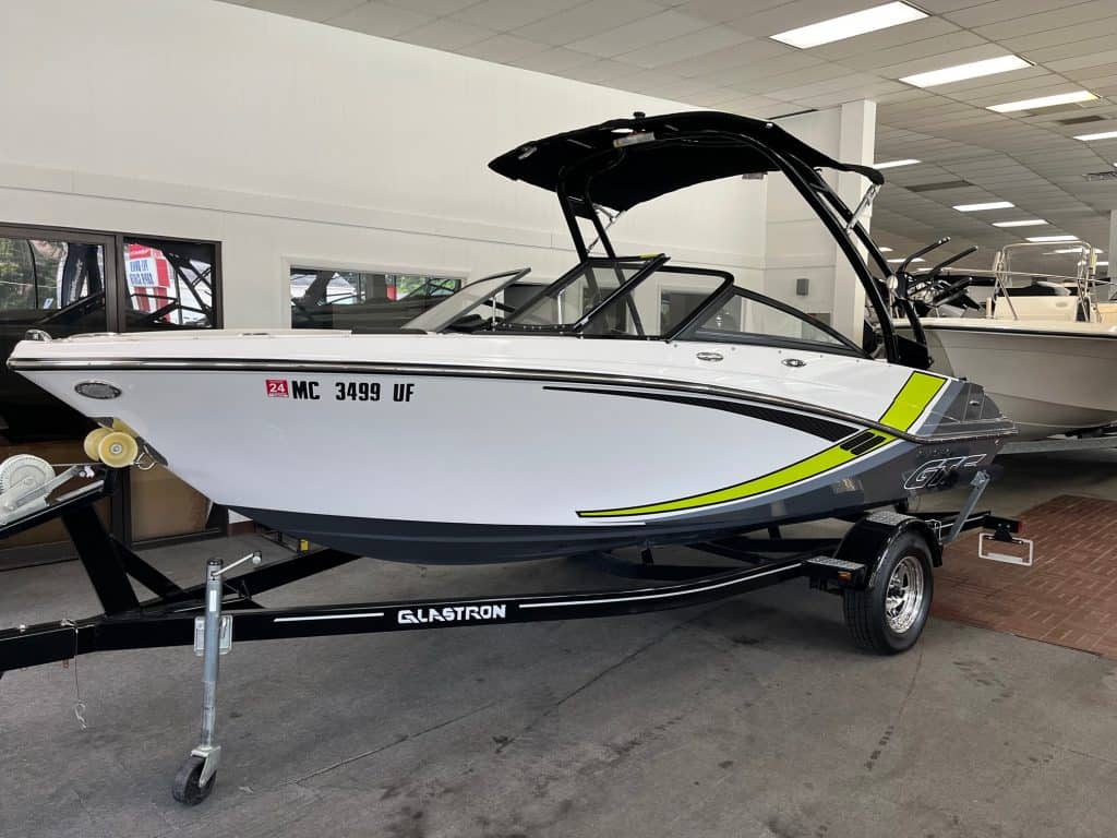 High-performance recreational speedboat displayed at Hall's Sport Center with trailer for sale.