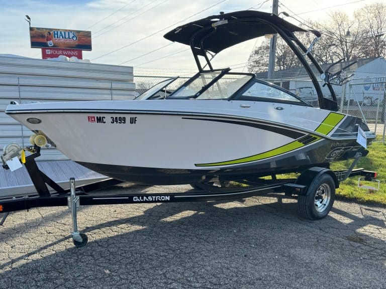 High-quality photo of a sleek, modern recreational boat on a trailer at Hall's Sport Center.