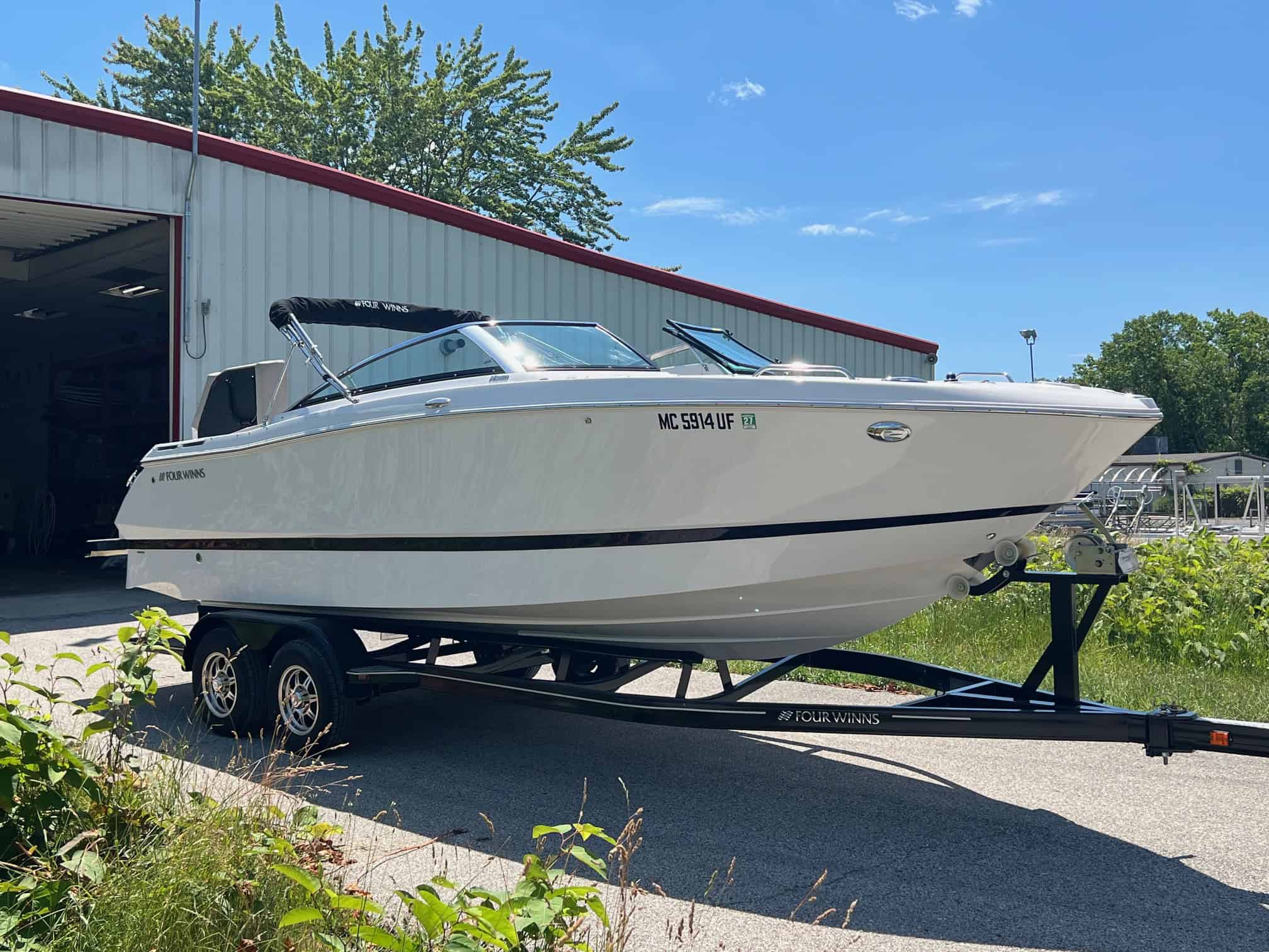 Four Winns H260 luxury boat on trailer at Hall's Sport Center.