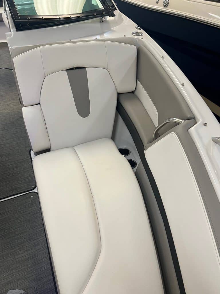 Comfortable white boat seating with cushioned backrest and armrest, ideal for leisure on the water.