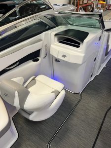 Boat cockpit with modern helm and seating.