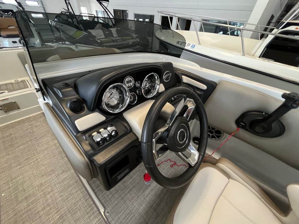 High-quality boat cockpit featuring a sleek dashboard, gauges, and steering wheel at Hall's Sport Center.