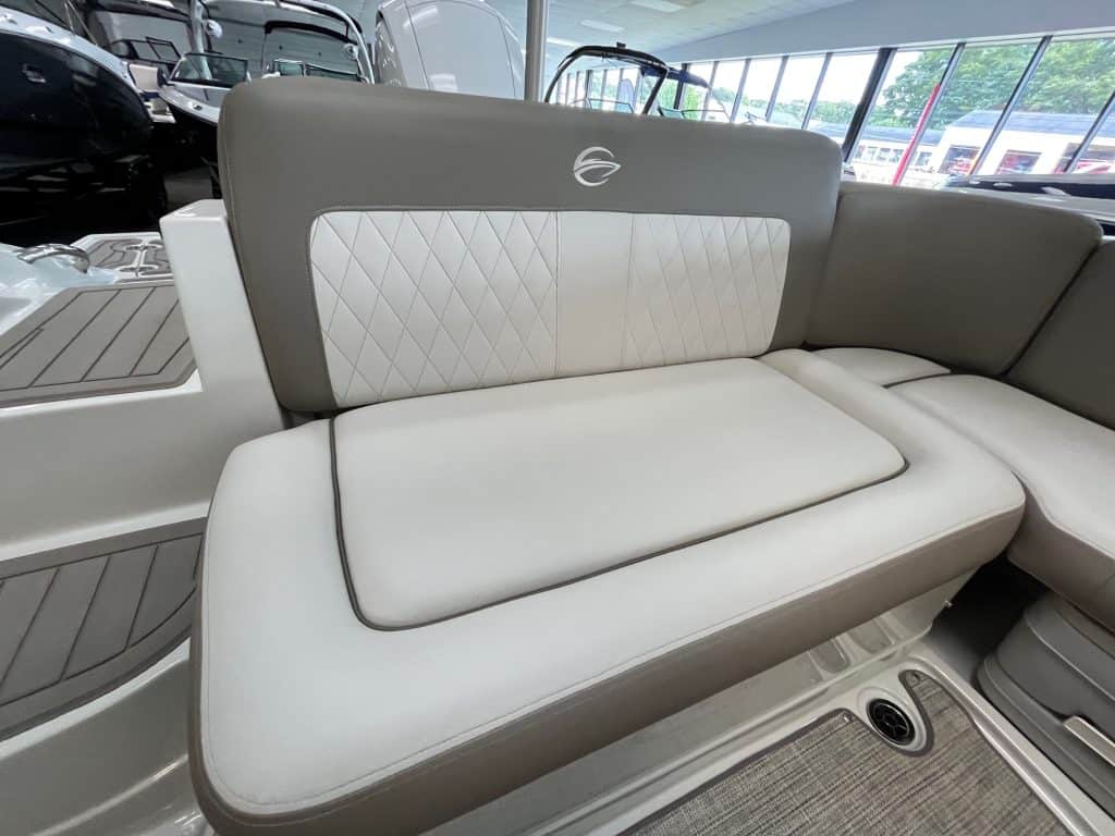 Boat seating with premium white and gray quilted cushions, ideal for comfortable cruising and outdoor leisure on the water.