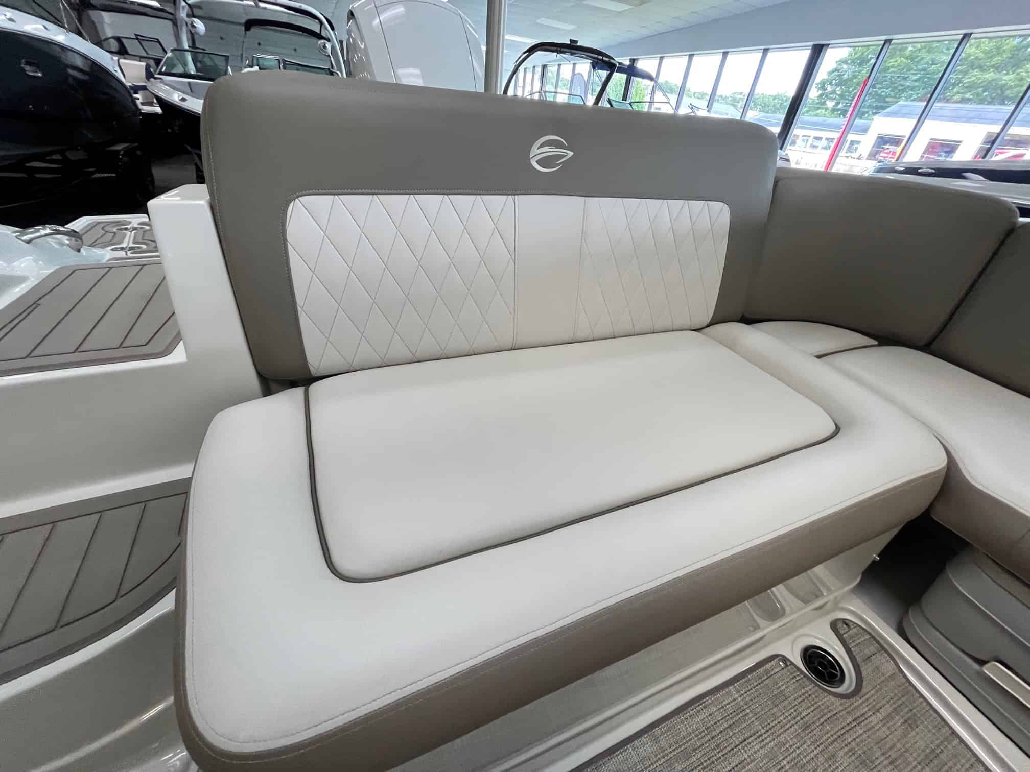 Boat seating with premium white and gray quilted cushions, ideal for comfortable cruising and outdoor leisure on the water.