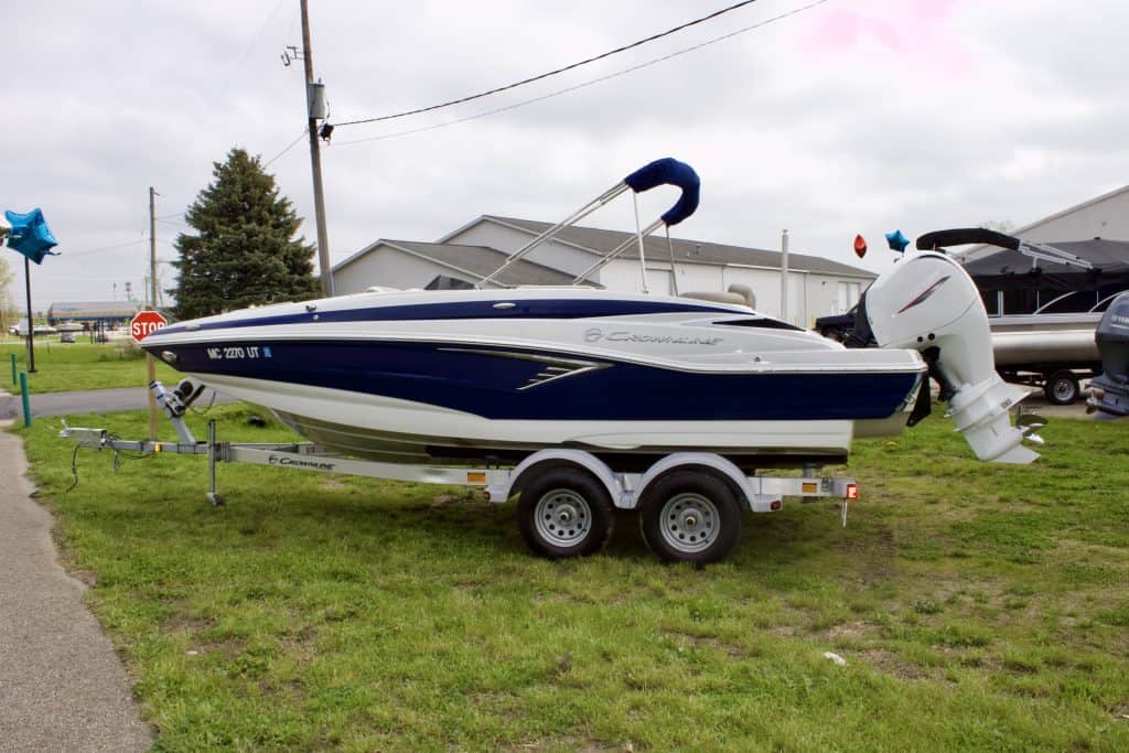 Speedboat on trailer with outboard motor at Hall's Sport Center, perfect for boating adventures.
