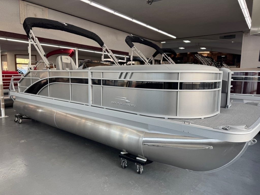 Modern aluminum pontoon boat displayed at Hall's Sport Center for sale.