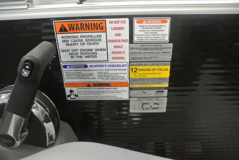 Boat engine warning label with safety instructions, maximum capacity, and emissions info for boating safety.