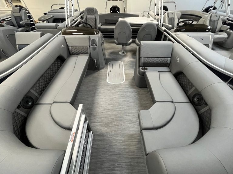 Comfortable gray pontoon boat lounge with diamond-stitched accents and built-in speakers.
