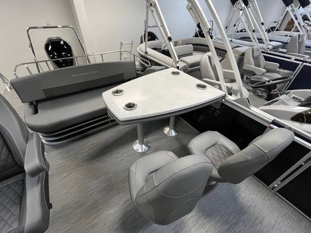 Pontoon boat with seating, table, and fishing gear at Hall's Sport Center.