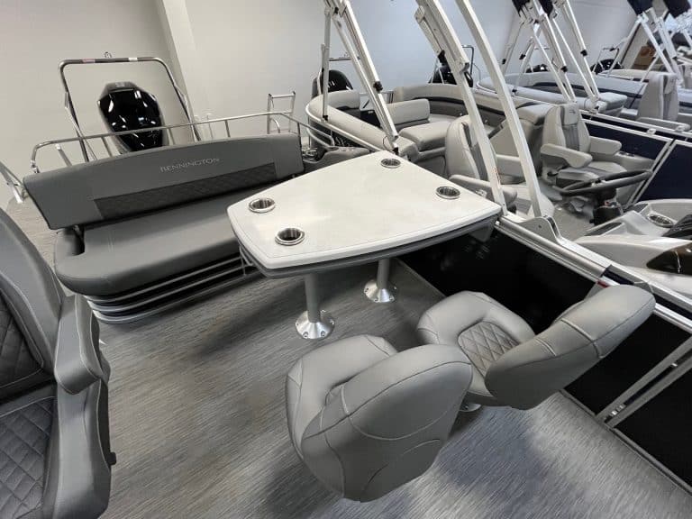 Pontoon boat with seating, table, and fishing gear at Hall's Sport Center.