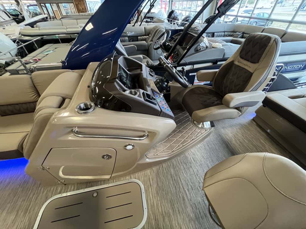 High-resolution image of a deluxe pontoon boat captain seating with a multifunctional console at Hall's Sport Center.