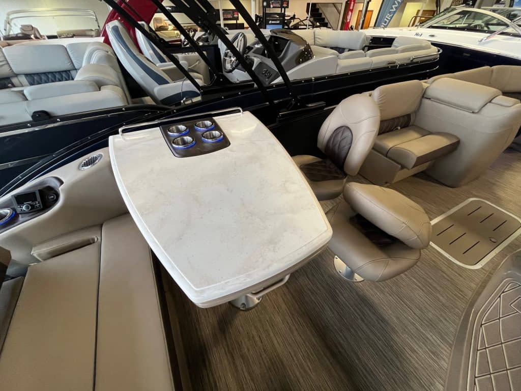 High-quality boat interior with plush seating, a steering console, and conversation area at Hall's Sport Center.