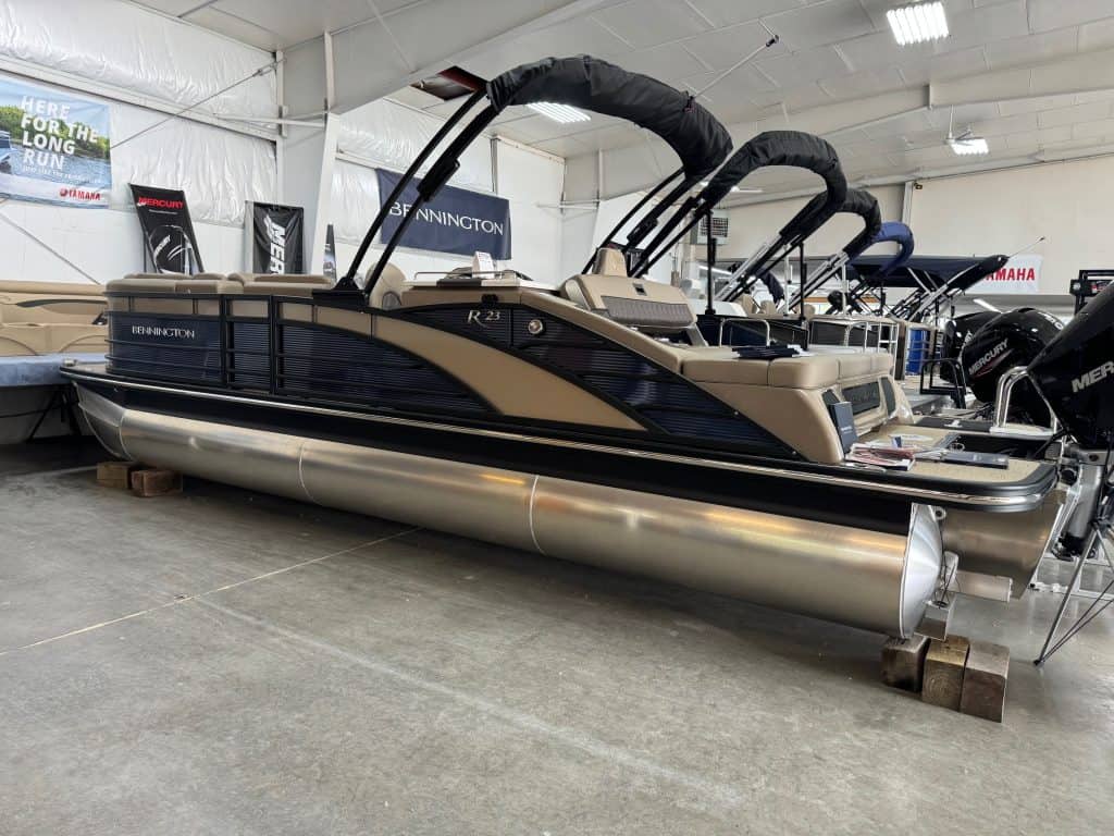 High-quality Bennington pontoon boat with black and beige exterior, spacious seating, powerful engine, perfect for lakes.