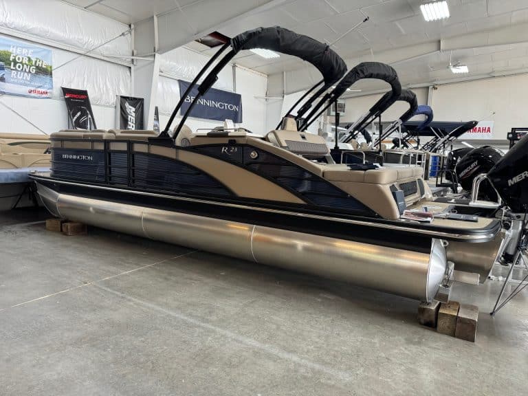 High-quality Bennington pontoon boat with black and beige exterior, spacious seating, powerful engine, perfect for lakes.
