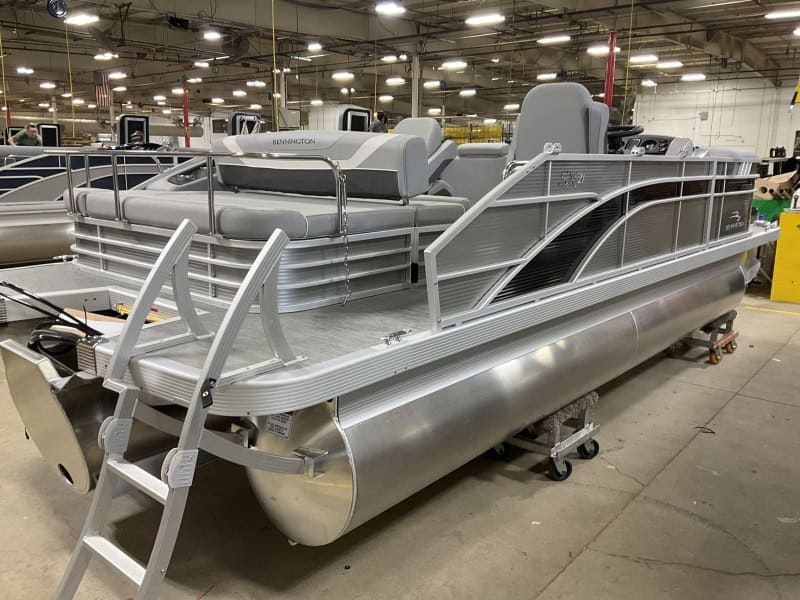 Comfortable aluminum pontoon boat with seating and safety rails. Ideal for lake outings and water adventures.