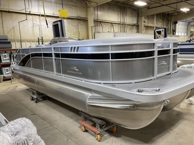 Modern Bennington pontoon boat for water sports and leisure. Perfect for family outings and aquatic adventures.