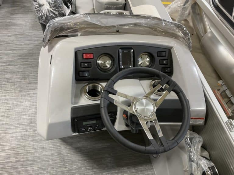 Alt text: Marine boat steering console with dashboard, gauges, and steering wheel for sale at Hall's Sport Center.