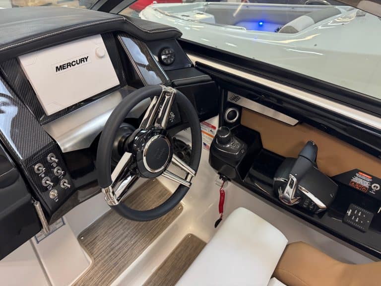 Luxury boat helm with advanced navigation system and Mercury controls.