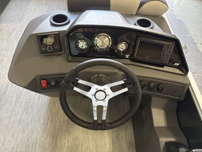 Dashboard of a Bennington 20SL S1 pontoon boat with gauges and navigation system.