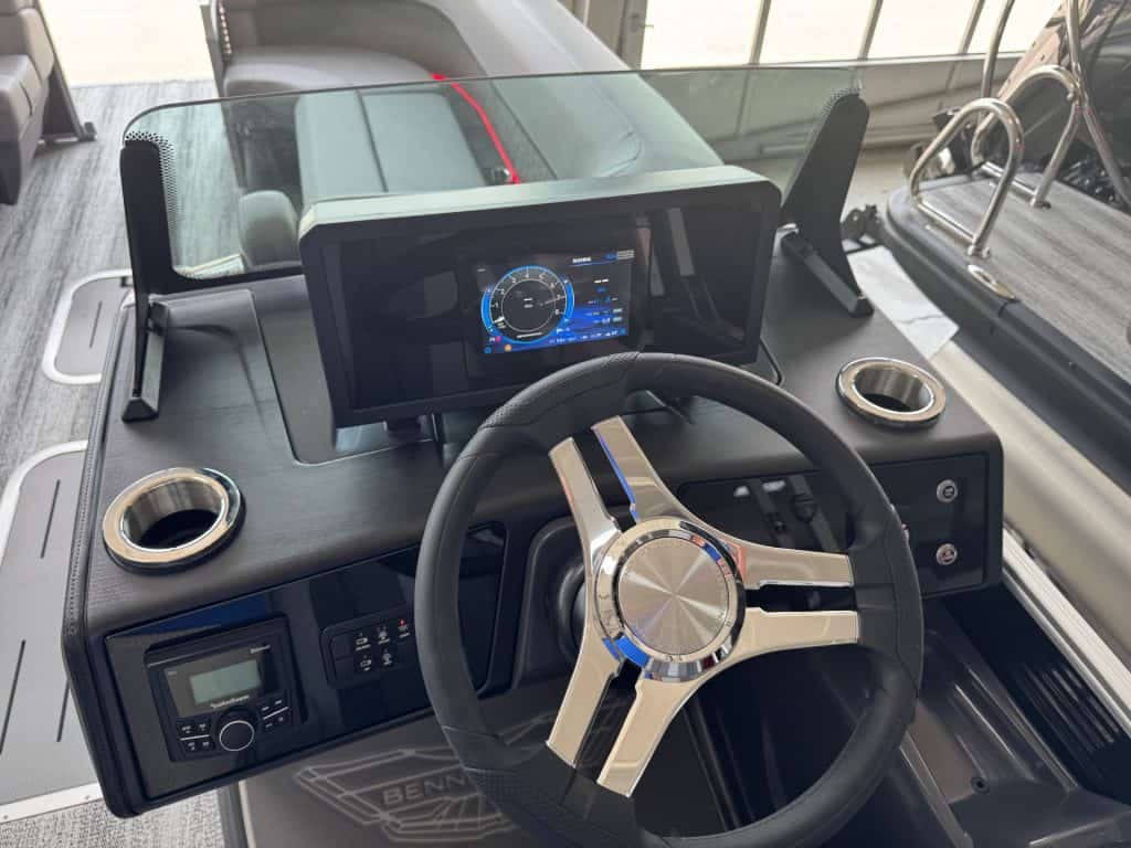 Bennington 24 MFB boat dashboard with digital display and steering wheel.