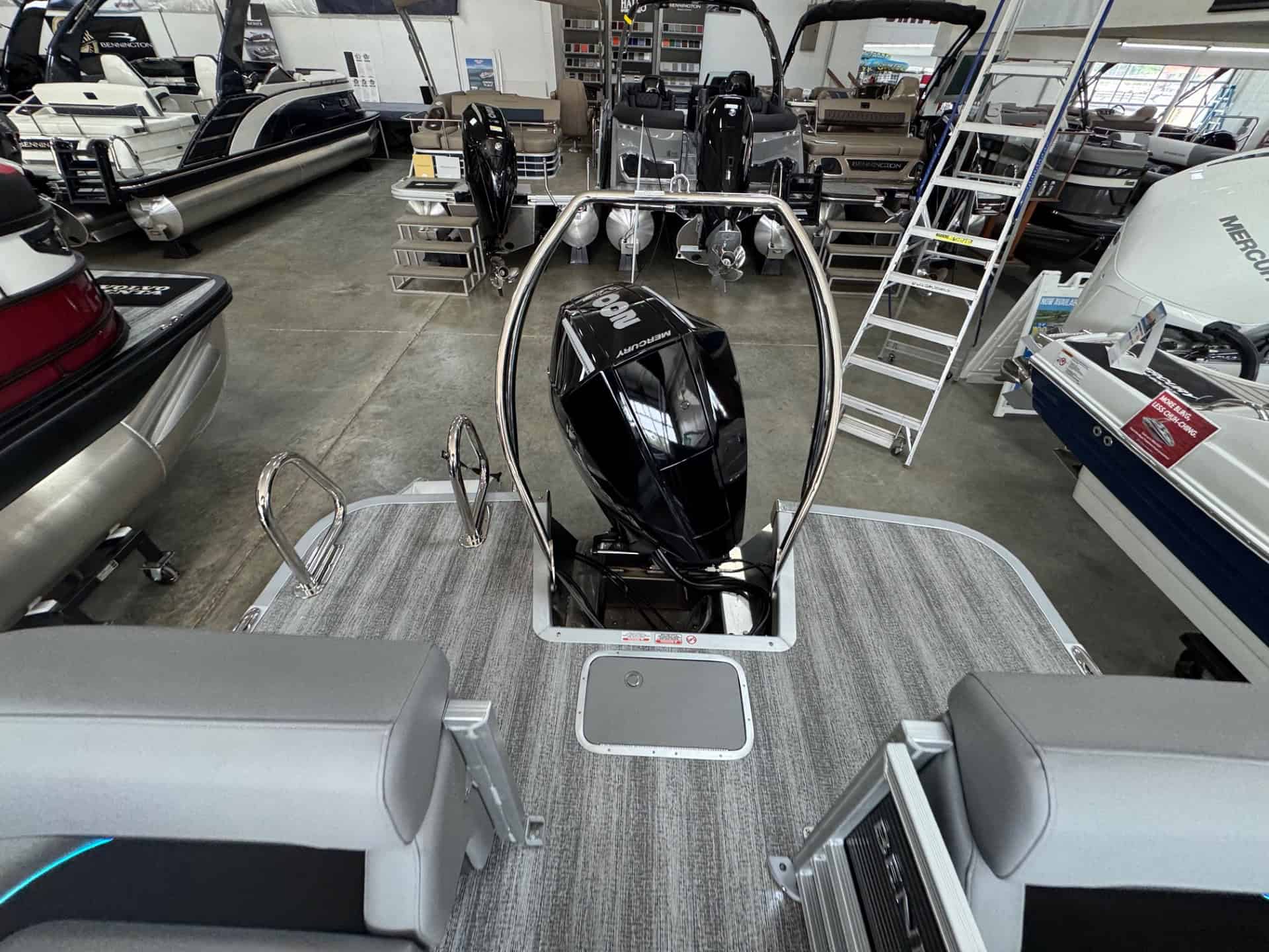 Bennington 24 MFB pontoon boat with outboard motor on display at Hall's Sport Center.