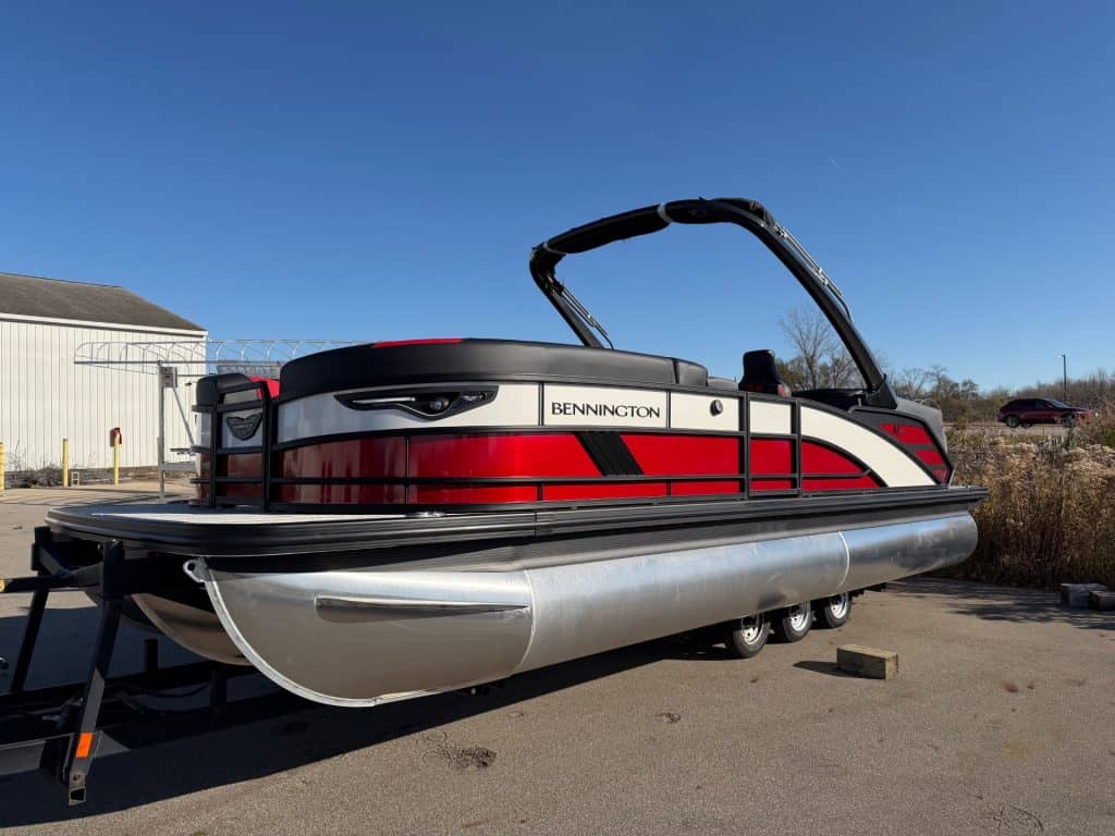 Modern Bennington 24 MFB pontoon boat displayed outdoors at Hall's Sport Center.