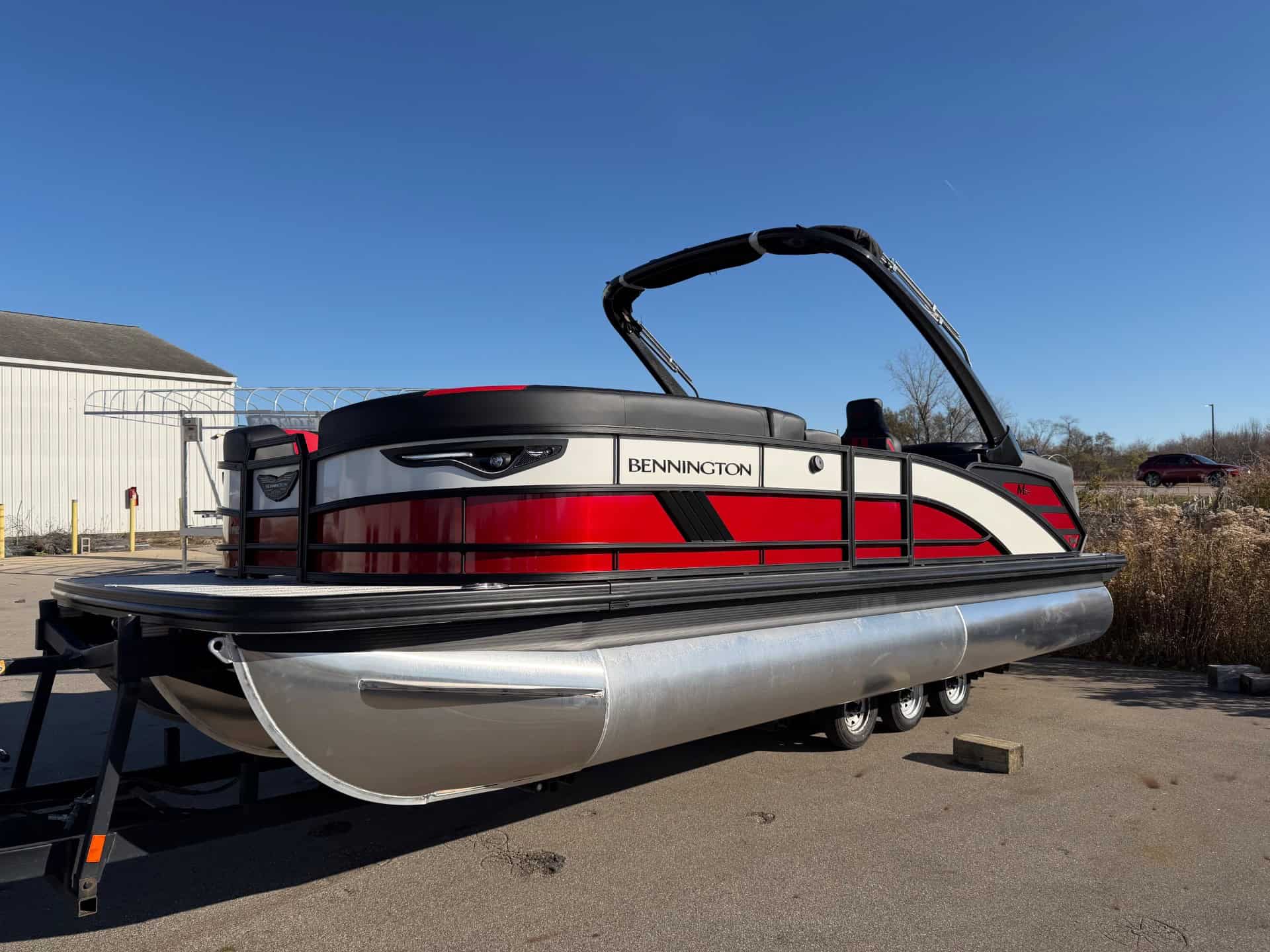 Modern Bennington 24 MFB pontoon boat displayed outdoors at Hall's Sport Center.