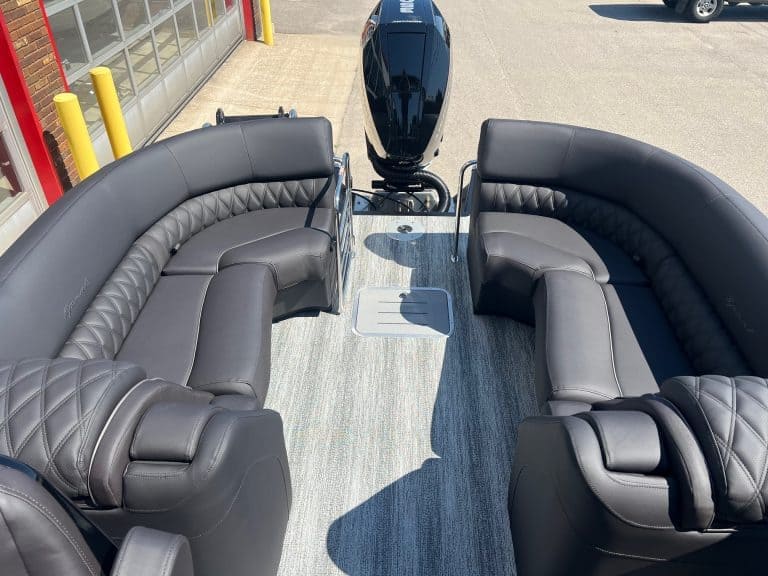 Modern Bennington 25 QFBA pontoon boat with black seating and outboard motor at Hall's Sport Center.