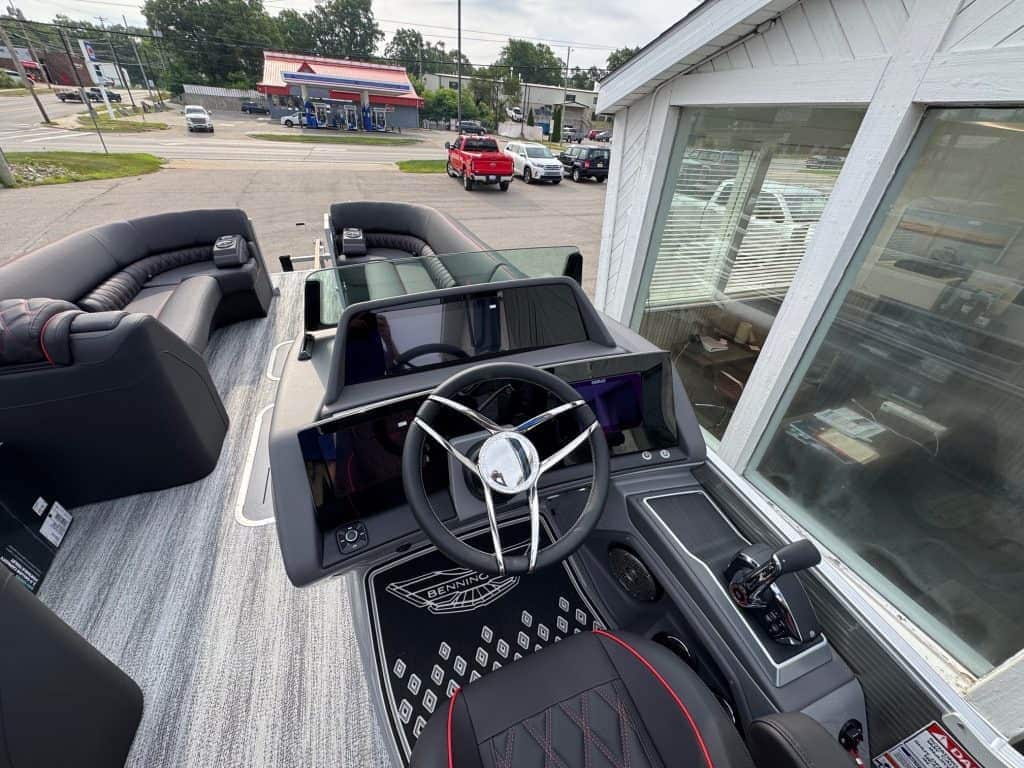 Bennington 25 RSBA luxury pontoon boat with modern dashboard and steering wheel.